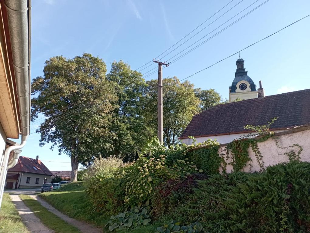 a building with a clock tower on top of it at Apartmán Putim in Písek