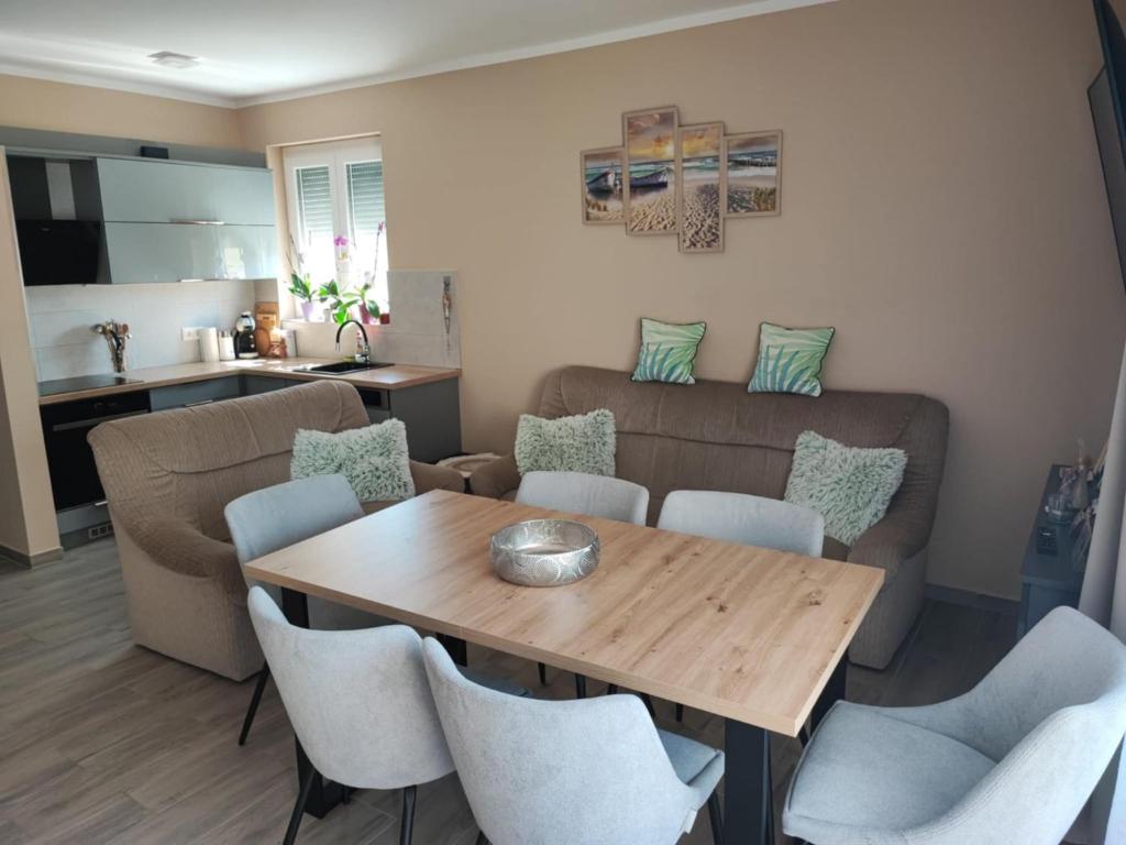 a living room with a table and chairs and a couch at Aminyaralónk in Balatonmáriafürdő