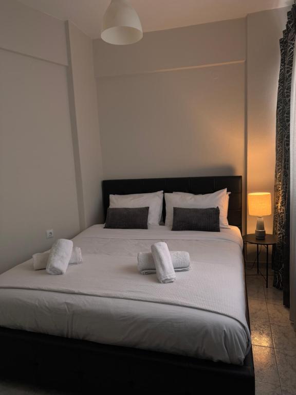 a bedroom with a large bed with two pillows on it at HERA QUEEN Boutique in Larisa