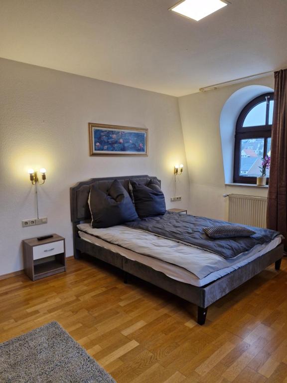 a bedroom with a large bed and a window at Stadtvilla Zimmervermietung in Heidenheim