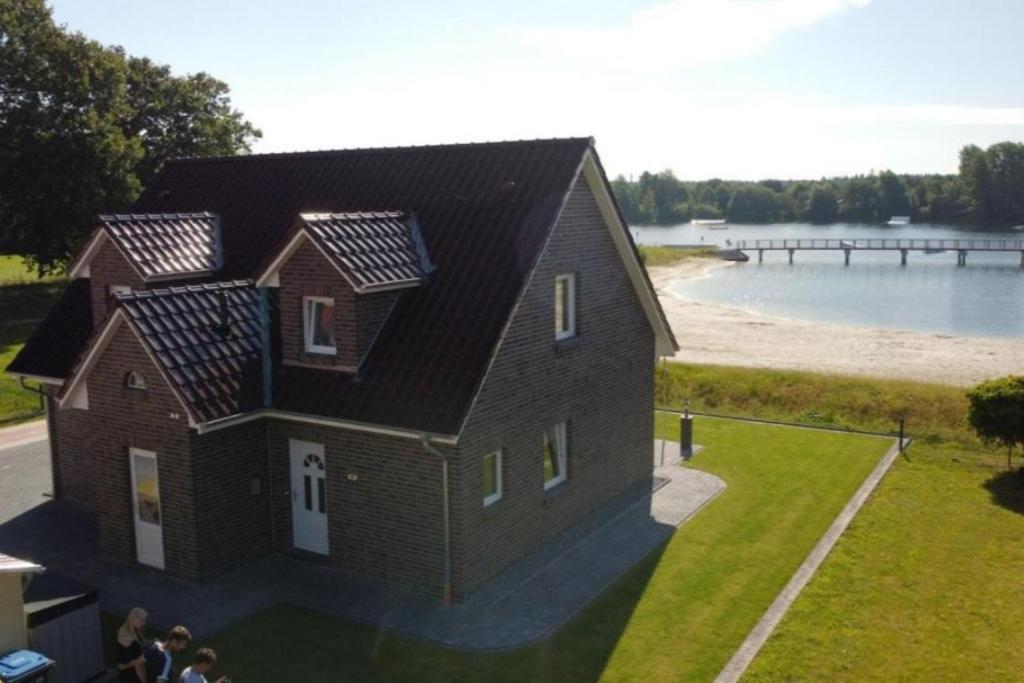 a rendering of a house with solar panels on it at NEU! Ferienhaus Schöne Aussicht direkte Strandlage in Aurich
