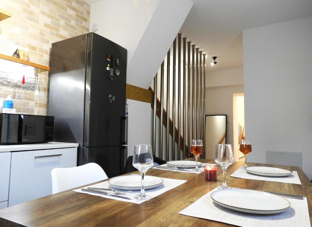 a kitchen with a wooden table with glasses of wine at Angelica Residence - Perfect Quiet Center Location - 10mins Walk to Gennadi Beach in Gennadi