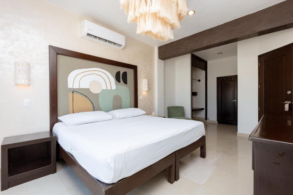 Cama ou camas em um quarto em Hotel Kinich
