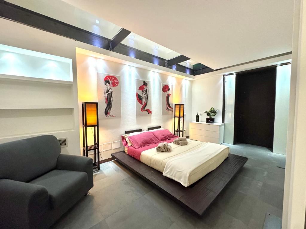 a bedroom with a large bed and a couch at Industrial Loft - Garage-Netflix-wifi in Brescia
