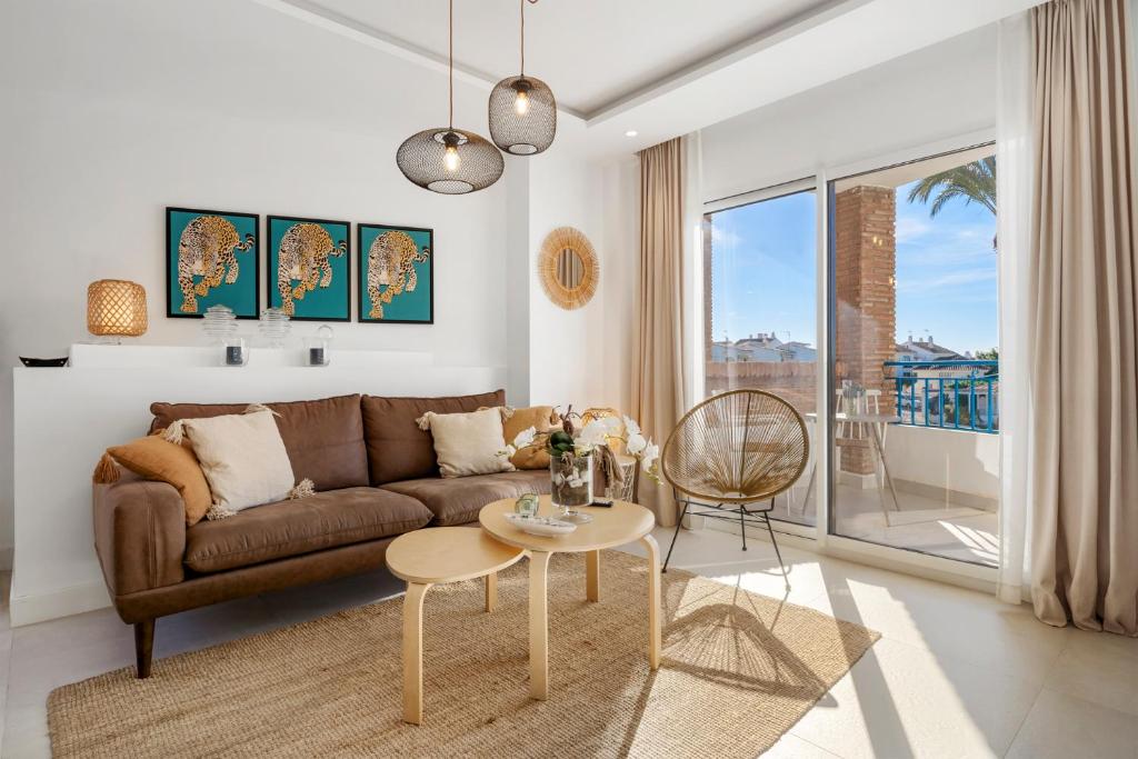 a living room with a couch and a table at Beautiful Family Apartment by Costarentals- Ref 24 in Sitio de Calahonda