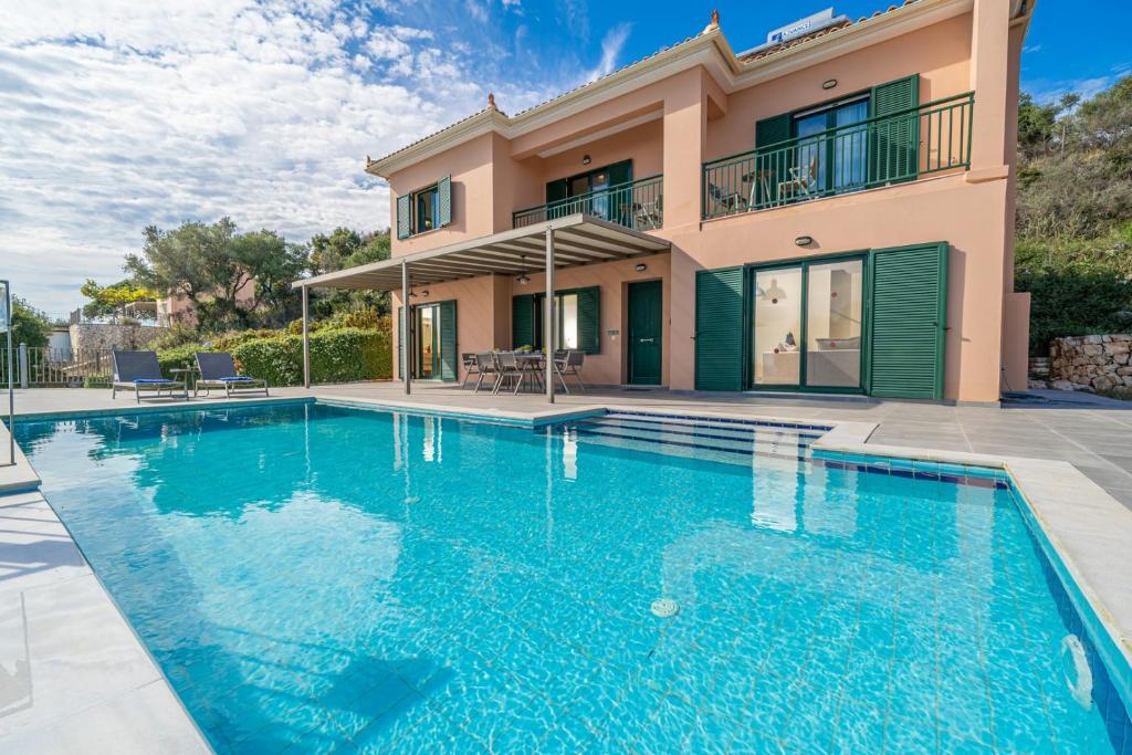 a large swimming pool in front of a house at Villa Niki with swimming pool in Kefallonia