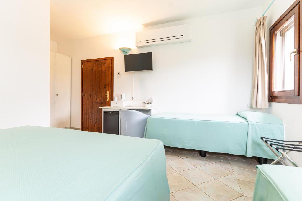 Postel nebo postele na pokoji v ubytování Hotel Villa Gemella