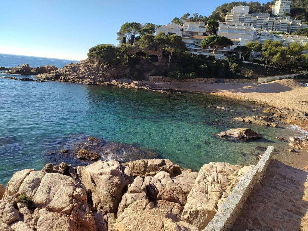 a view of a beach with rocks and condos at Xalana con terraza y magnificas vistas al mar in Girona