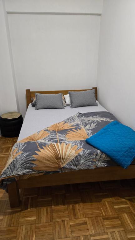a bedroom with a bed with a colorful comforter at Apartman Aylin 2 in Tuzla