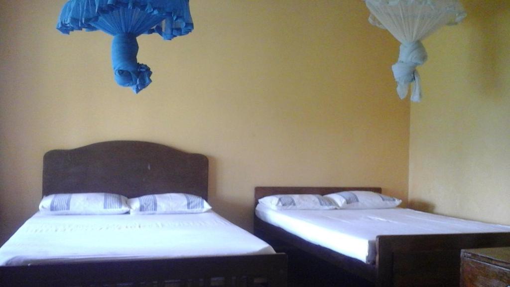 Postel nebo postele na pokoji v ubytování Mount Crest Inn Deniyaya