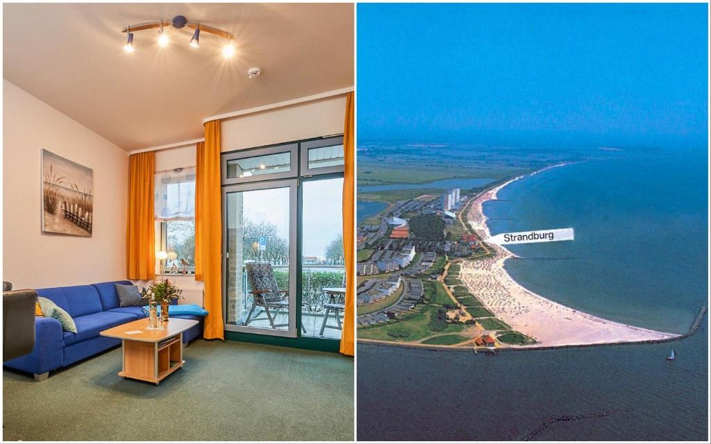 a living room with a blue couch and a view of the ocean at Strandburg-Küken in Fehmarn