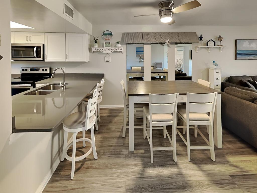 a kitchen and living room with a table and chairs at Ocean Village Club J24 in Saint Augustine