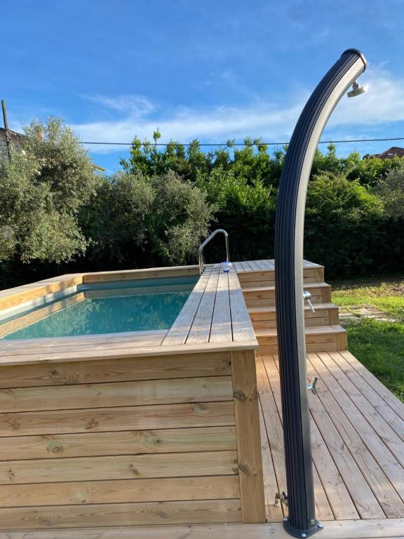 a hot tub on a wooden deck with a light pole at Casa degli Zii appartamento Letizia in Luni