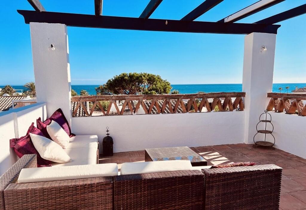 a patio with a couch and a view of the ocean at Casa Carmen in Marbella