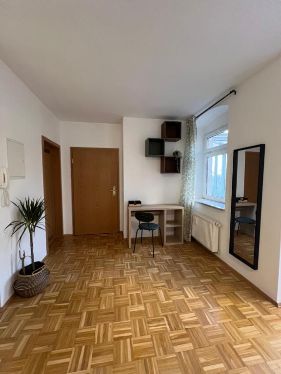 an empty room with a desk and a table at Study & Work am Campus Chemnitz in Chemnitz