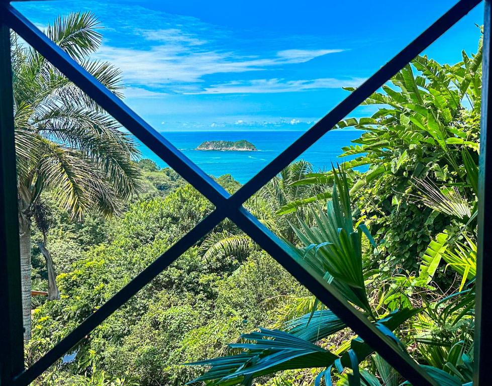 a view of the ocean from a window at Villa Roca Boutique Resort & Suites - ADULT ONLY in Manuel Antonio