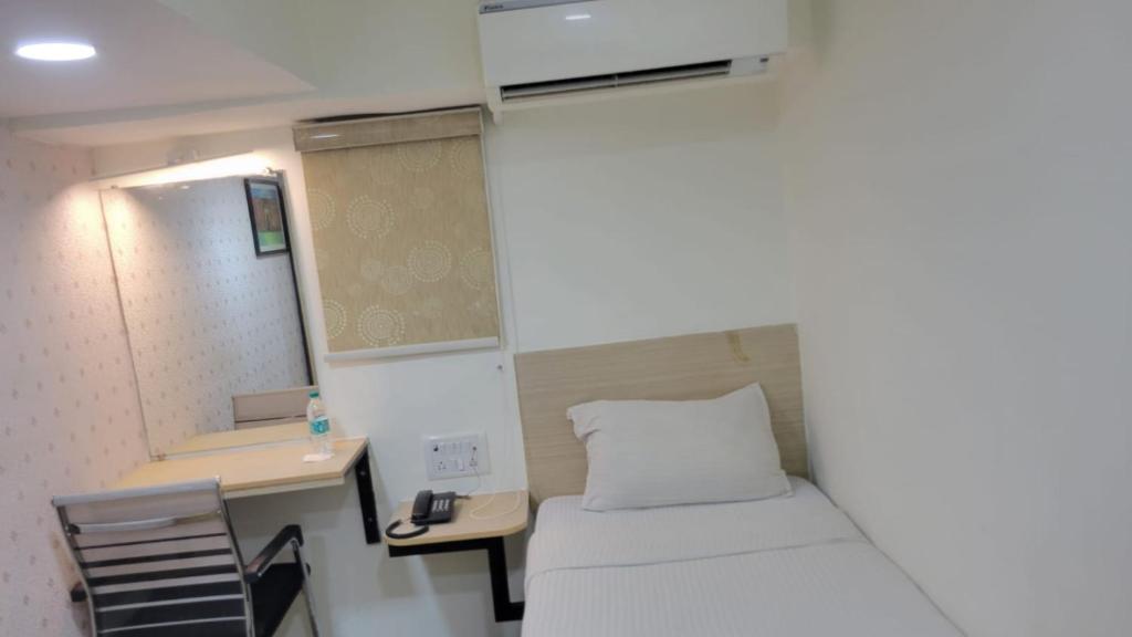 Postel nebo postele na pokoji v ubytování Grace Residency Chennai Airport