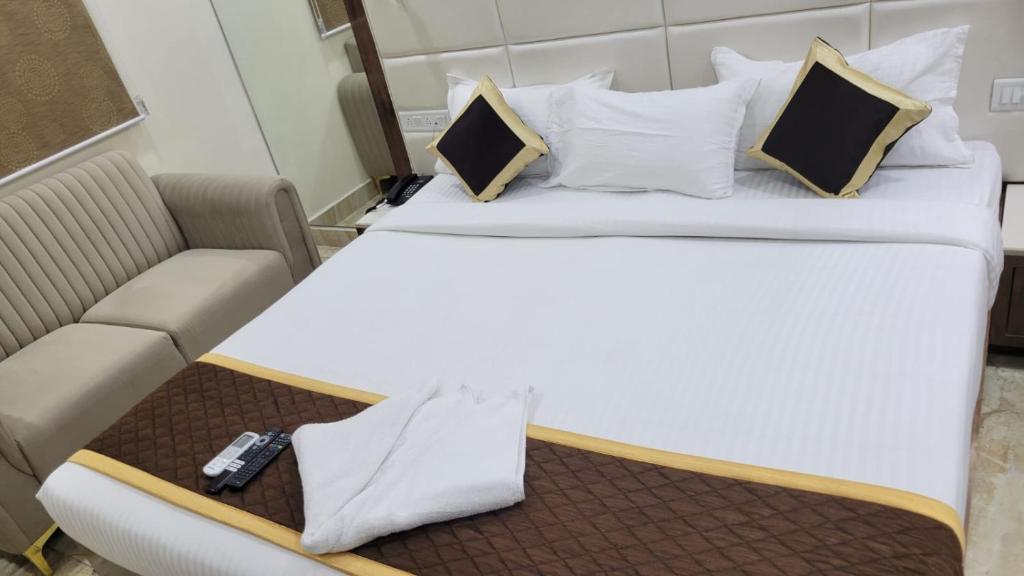 Postel nebo postele na pokoji v ubytování Grace Residency Chennai Airport