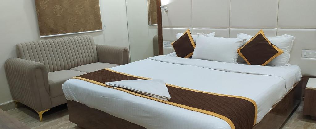 Postel nebo postele na pokoji v ubytování Grace Residency Chennai Airport