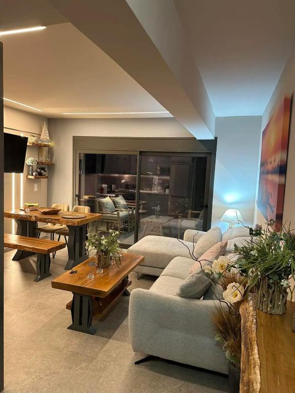 a living room with a couch and tables in it at September15 Suites, Lefkada-Episkopos in Nikiana