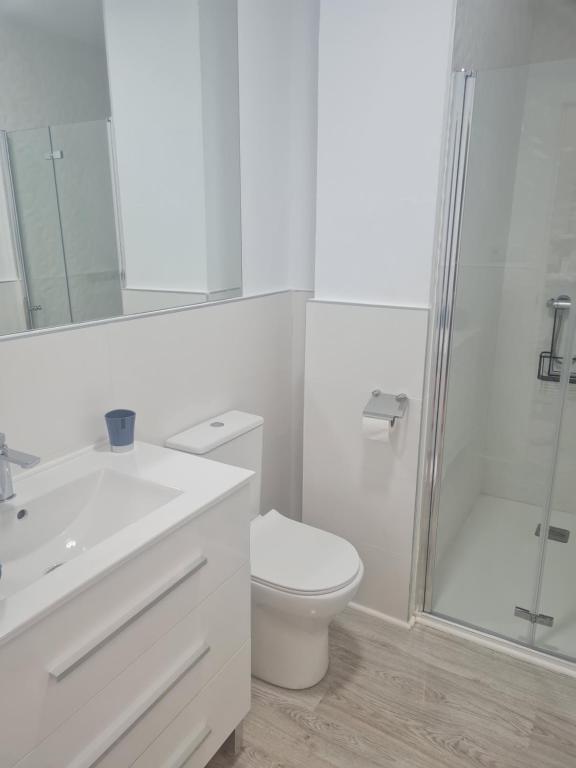 a white bathroom with a toilet and a shower at Apartment Azul in Santa Pola