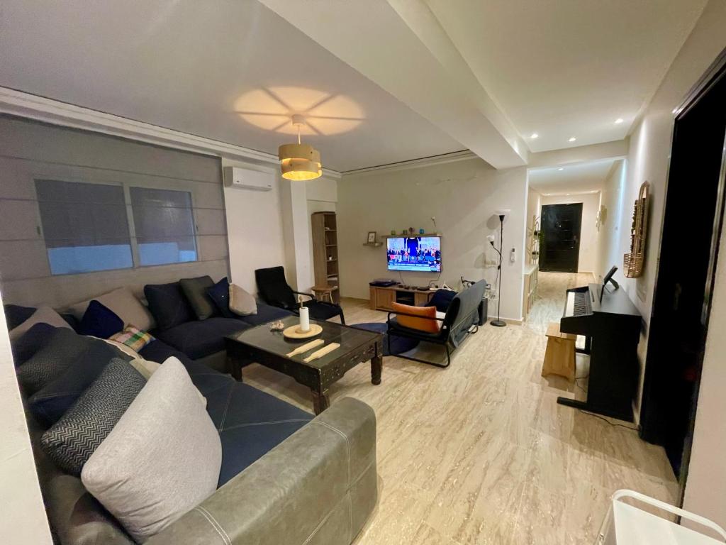 a living room with a couch and a table at Les Nuits de Miel - Marrakech in Marrakech