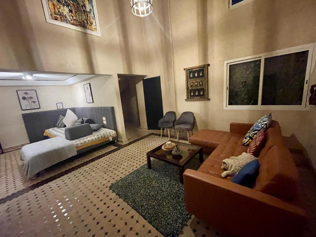 a living room with a couch and a bed at Au Riad Des Sultans - Marrakech in Marrakech