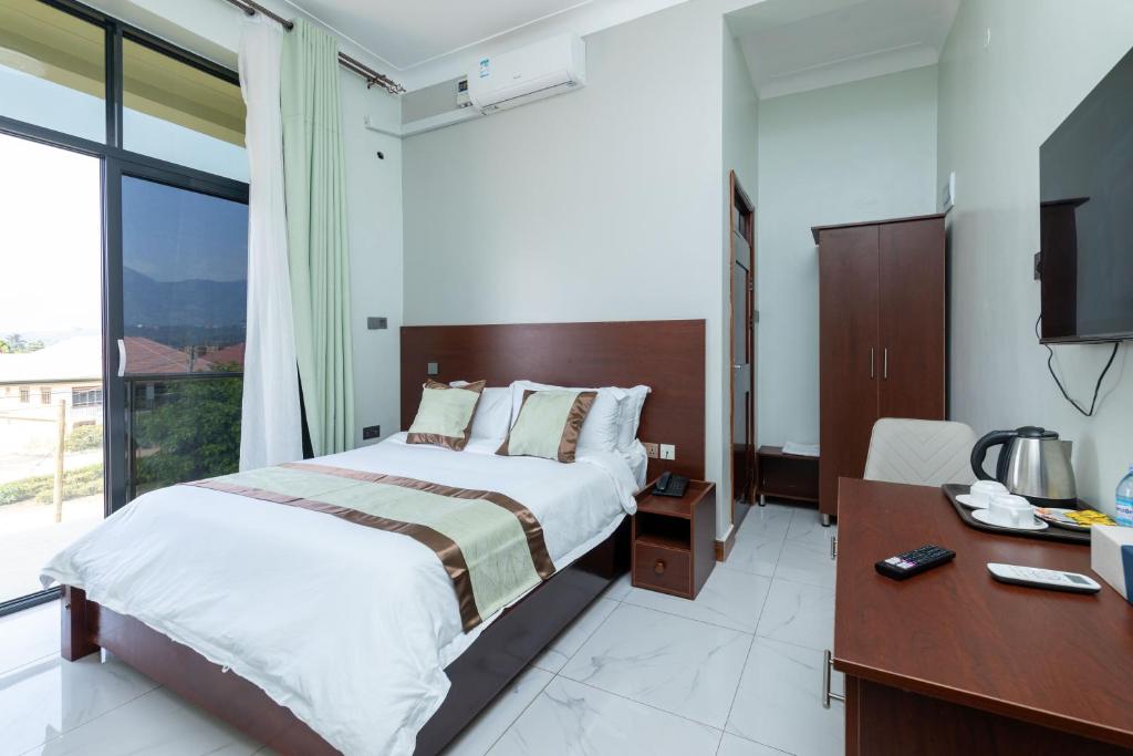 Postel nebo postele na pokoji v ubytování Ngabu Hotel
