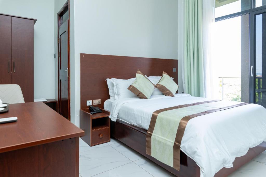 Postel nebo postele na pokoji v ubytování Ngabu Hotel