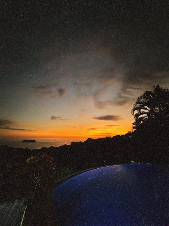 a view of a sunset from a swimming pool at Villa Roca Boutique Resort & Suites - ADULT ONLY in Manuel Antonio