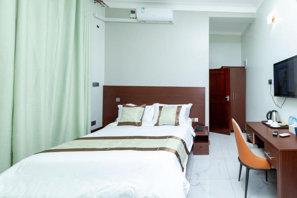 Postel nebo postele na pokoji v ubytování Ngabu Hotel