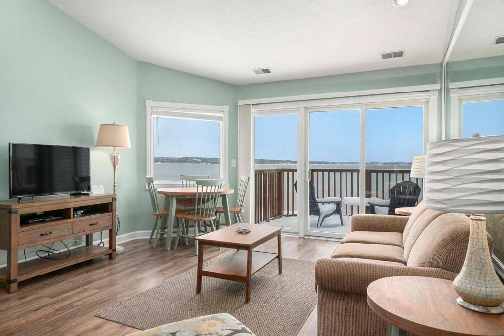 a living room with a couch and a television at Beachside 325 Waterfront Condo in Traverse City