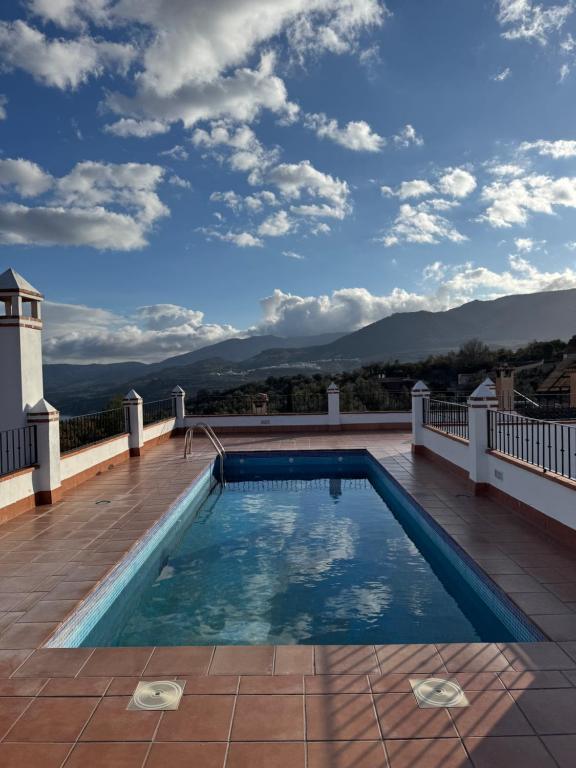a swimming pool on the roof of a house at La Corrala de Chite in Lecrin