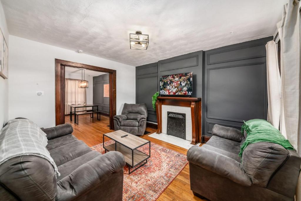a living room with two couches and a fireplace at The Cobblestone Townhouse - 2 BR -German Village in Columbus
