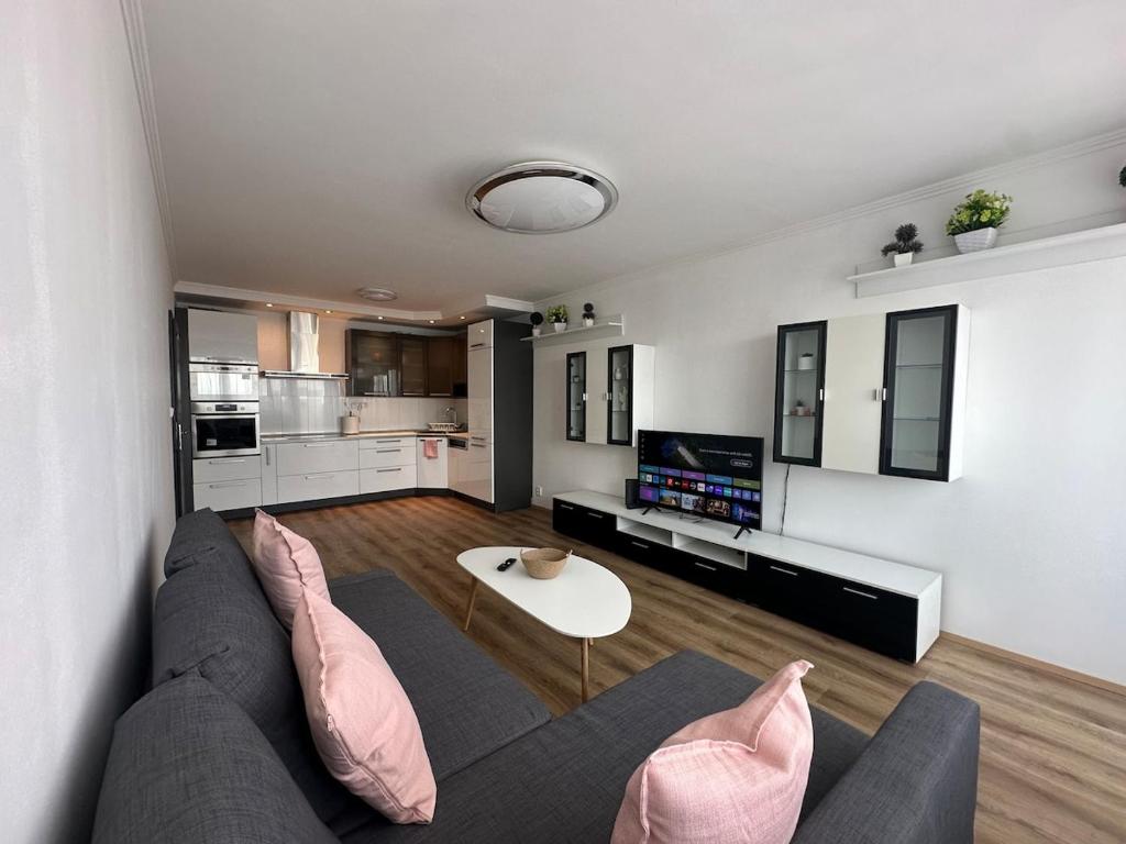 a living room with a couch and a table at High rise cozy 2BRD flat in Prague