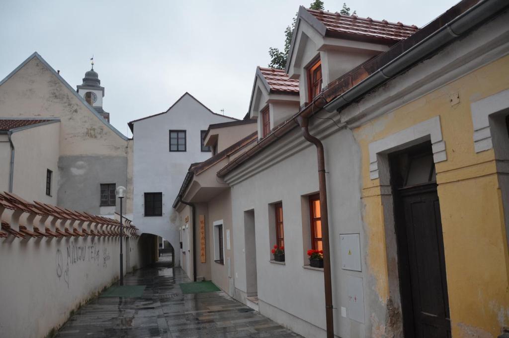 an alley in an old town with white buildings at Apartment U Karla in Třeboň