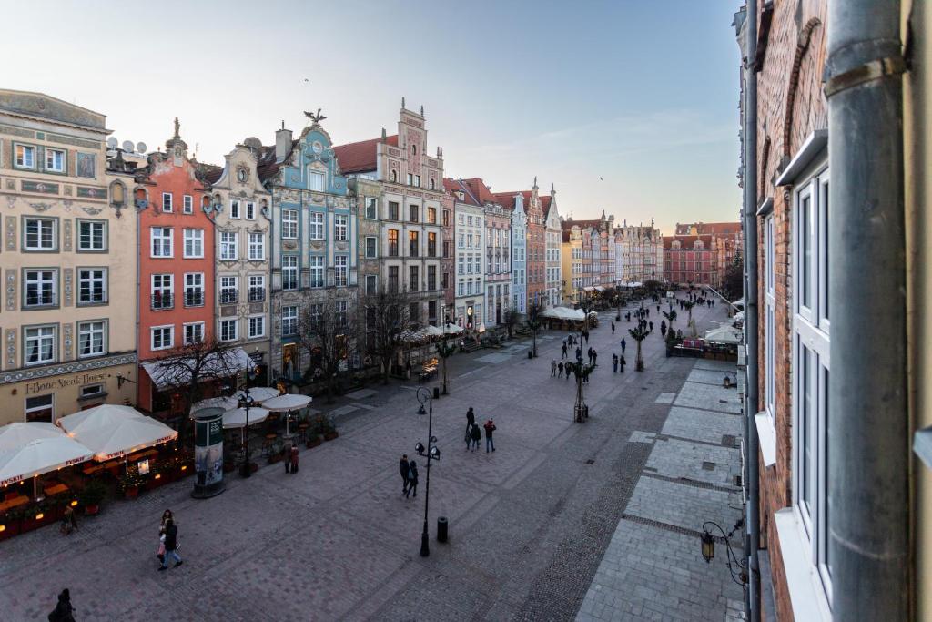 a city street with people walking around and buildings at Old Town Heaven Apartment in Gdańsk