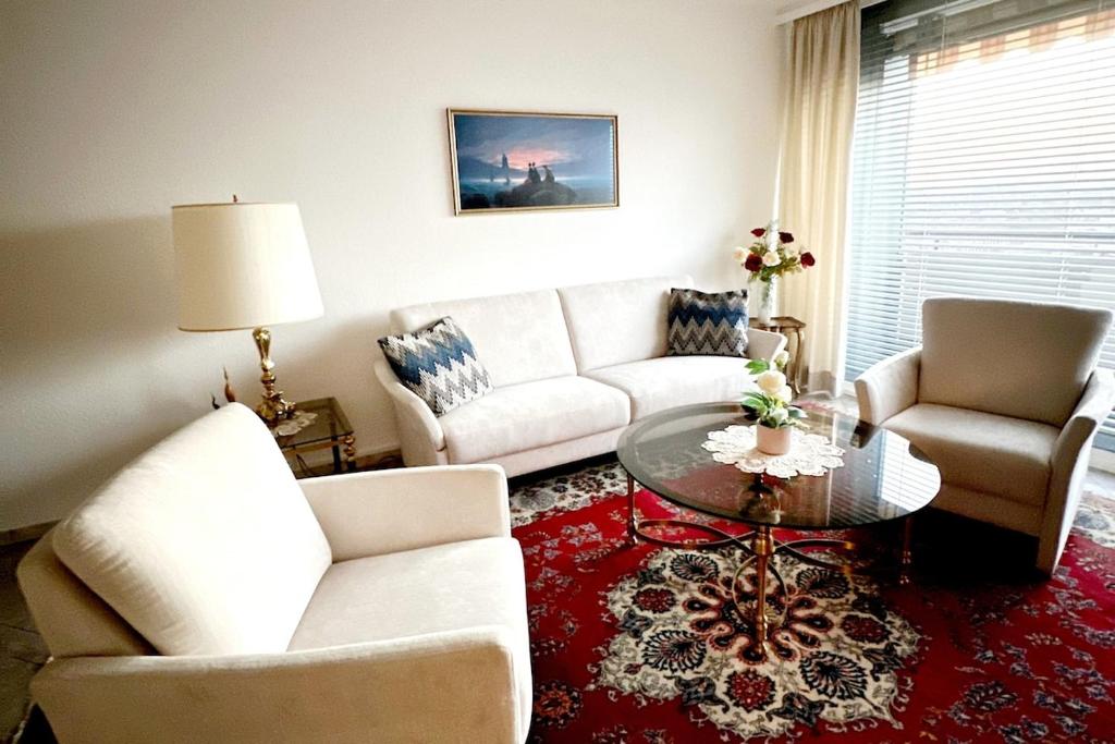 a living room with a white couch and a table at 2 Zimmer Wohnung für 2 in Mülheim an der Ruhr