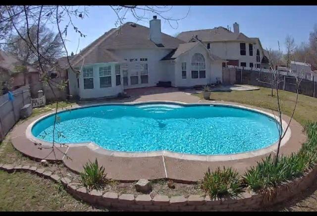 a large swimming pool in front of a house at Comfy 3-Bedroom Home in Arlington in Arlington