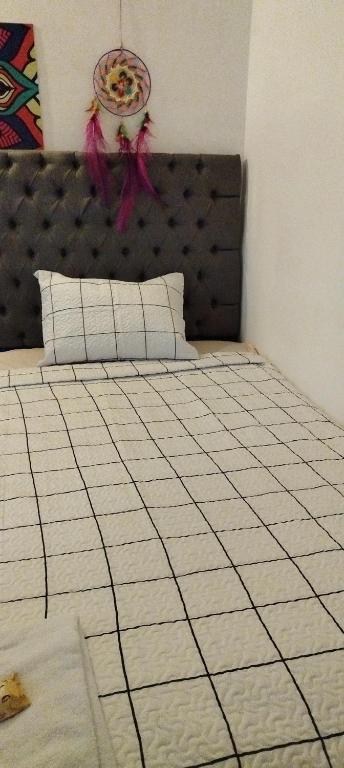 A bed or beds in a room at Hostal Maison Belle