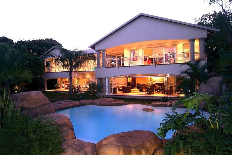 a large house with a large pool in front of it at uShaka Manor Guest House in Durban