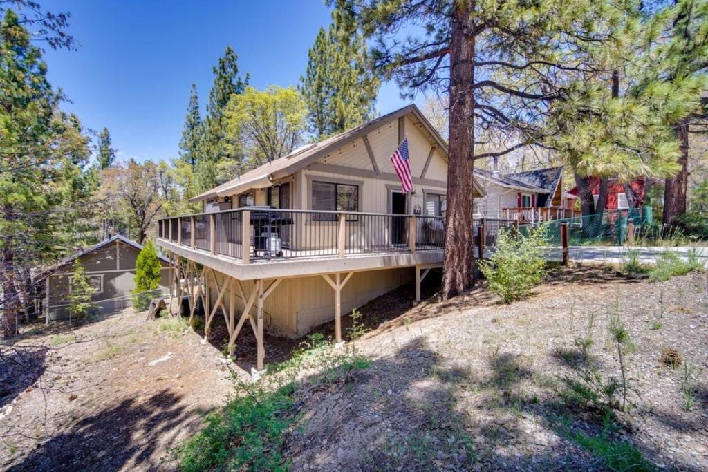 a house with a wrap around porch with a deck at The Drowsy Den With Firepit & BBQ Plus Large Patio in Big Bear Lake