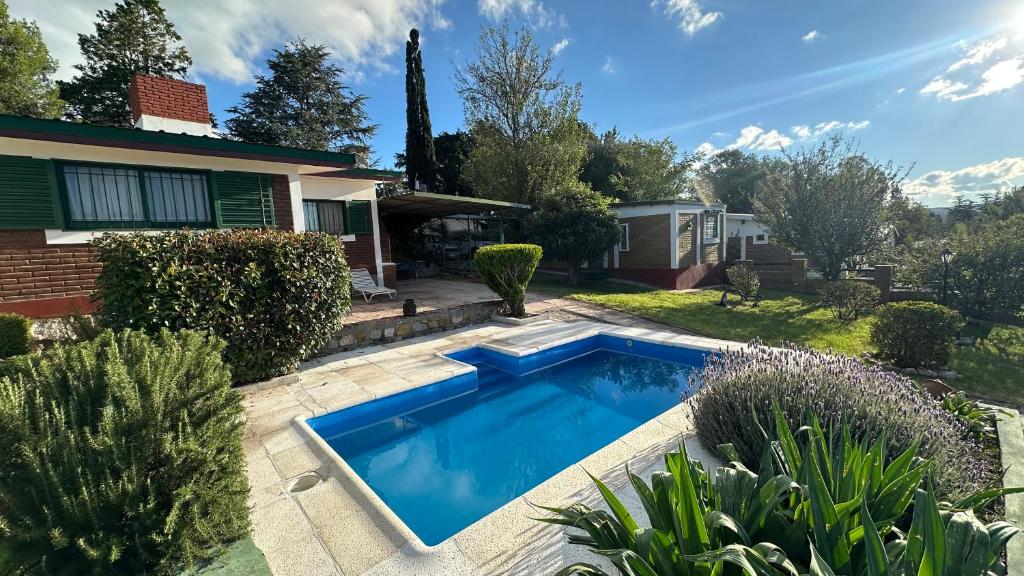 a swimming pool in the yard of a house at Los Prados in Villa Giardino