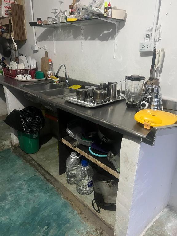 a kitchen with a counter with a sink in it at Atardecer De Salento in Salento