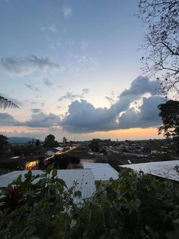 a view of a city at sunset with roofs at Atardecer De Salento in Salento