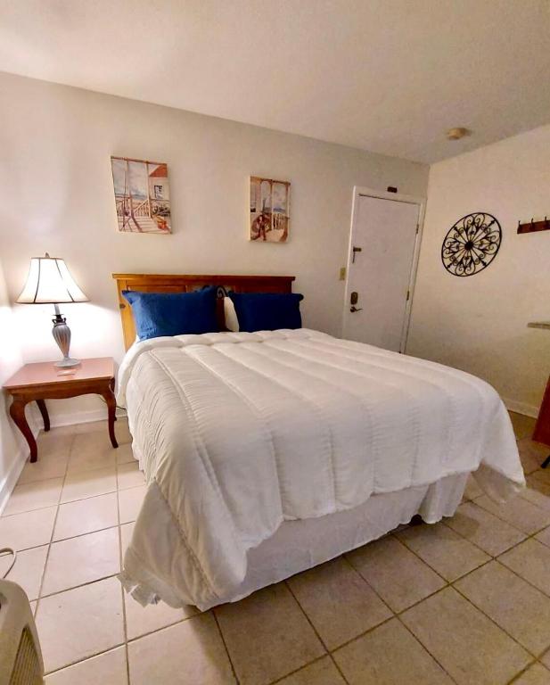 a bedroom with a large bed with a clock on the wall at Marina Vista Condo III in New Bern