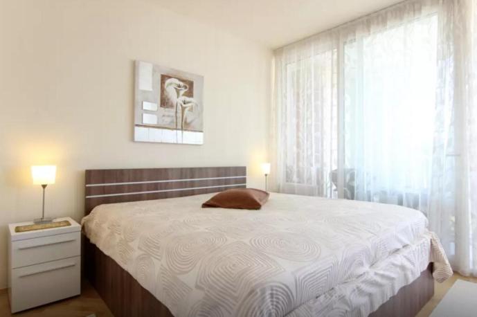 a bedroom with a large bed and a window at Apartment Ultra Split in Split