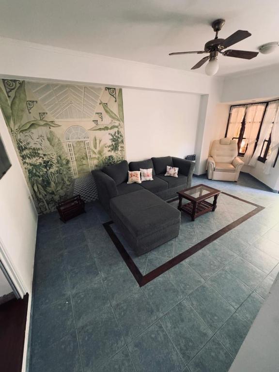 a living room with a couch and a table at Casa Cento in Santa Rosa de Calamuchita
