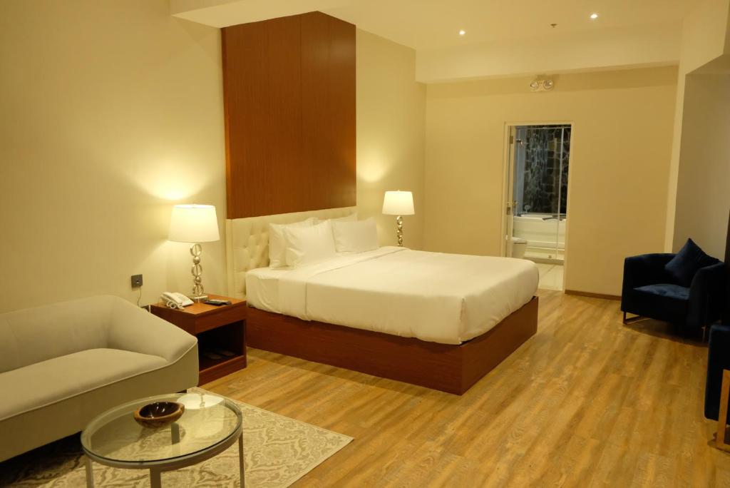a hotel room with a bed and a couch at Villa Isabel Hotel in Sorsogon