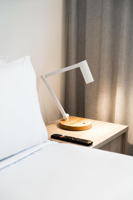 a lamp sitting on a table next to a bed at Mary MacKillop Place in Sydney
